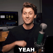 a man standing in front of a microphone with the word yeah written on his face