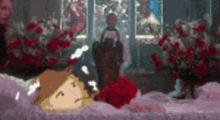 a cartoon character is laying in a coffin surrounded by red roses .