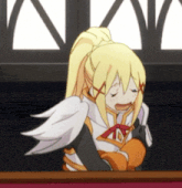 a girl with a ponytail is sitting at a table