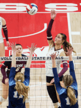 a volleyball game is being played in front of a banner that says state finals