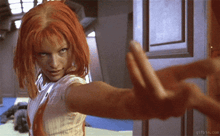 a woman with red hair is giving a middle finger