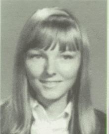 a black and white photo of a smiling woman with long hair