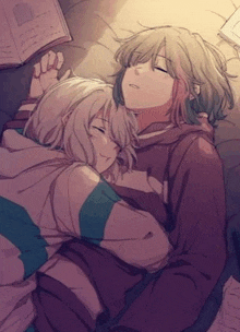 a couple of anime girls are hugging each other while sleeping on a bed .