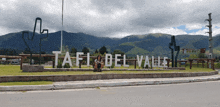 a sign that says tafil del valle in front of mountains