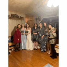 a group of women posing for a picture with a bride and her bridesmaids