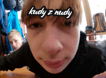 a close up of a boy 's face with the words kudy z nudy written on it