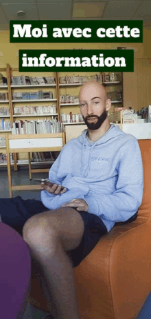 a man with a beard is sitting in a chair with a sign above him that says moi avec cette information