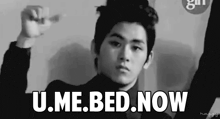 a black and white photo of a young man with the words " u.me.bed.now " above him