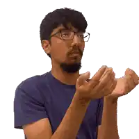 a man wearing glasses is clapping his hands