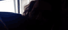 a close up of a person 's face looking out a window