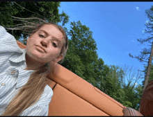 a young woman taking a selfie in front of trees