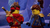 two lego figures are standing next to each other and one has a sword