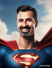 a man in a superman costume with the letter s on his chest is smiling