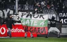 a man holding a flag that says gate 4 bulgaria on it