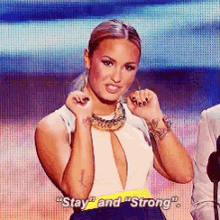 a woman says " stay " and " strong " while making a funny face