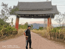 a huawei p30 pro leica quad camera takes a picture of a man standing in front of a wooden archway