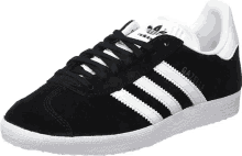 a pair of black adidas gazelle sneakers with white stripes