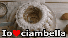 a cake with powdered sugar on it and the words io ciambella above it