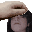 a hand is touching a woman 's forehead with a green screen in the background