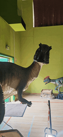 a statue of a dinosaur standing in a room