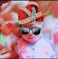 a baby wearing sunglasses and a turban with a reflection of new york city