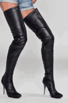 a woman wearing a pair of thigh high boots