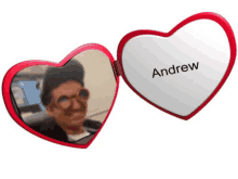 a heart shaped mirror with andrew written on the front