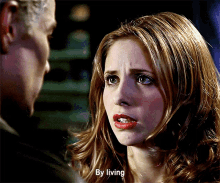 a woman with red lips is talking to a man and the words by living are visible