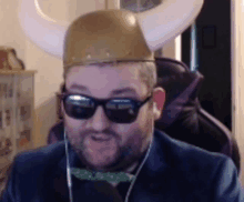 a man wearing a viking hat and sunglasses looks at the camera