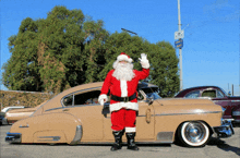 a man dressed as santa claus standing in front of a car