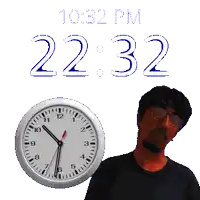 a man stands in front of a clock that says 10:22 pm