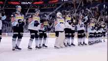 a group of hockey players are lined up on the ice and one of their jerseys says ' porto '