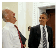 joe biden and barack obama laugh together in a room