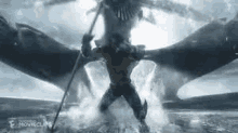 a man is fighting a dragon in the water while holding a stick .