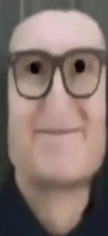a close up of a man 's face with glasses