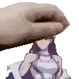 a hand is holding a picture of a girl in a purple dress over her head .