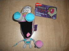 a stuffed animal with a card that says invader zim on it