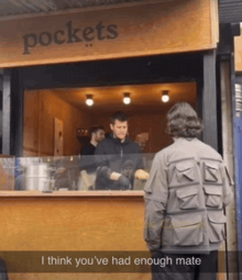 a man standing in front of a pockets restaurant