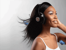 a woman wearing headphones with the letter q on the top