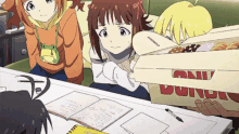 three anime girls are looking at a box that says donuts