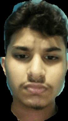 a close up of a young man 's face with a beard