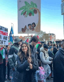 a woman is holding a sign that says " eartion trust a or emt "