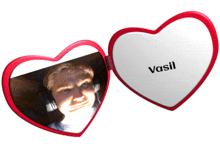 a heart shaped mirror has vasil written on the front