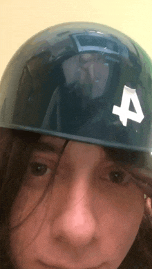 a close up of a person wearing a helmet with the number 4 on it