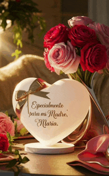 a heart shaped lamp with the words especialmente para mi madre maria on it