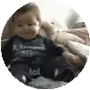 a baby is sitting on a couch in a circle with the word lol on his feet .