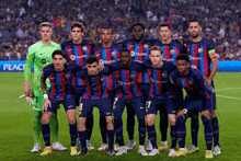 a soccer team is posing for a team photo on a soccer field .