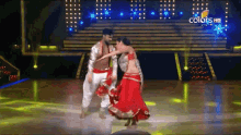 a man and a woman are dancing on a stage with the words colors hd in the background