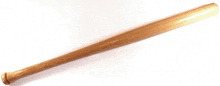 a long wooden baseball bat is sitting on a white surface