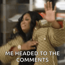 a woman is waving her hand and saying `` me headed to the comments '' while wearing a jacket .